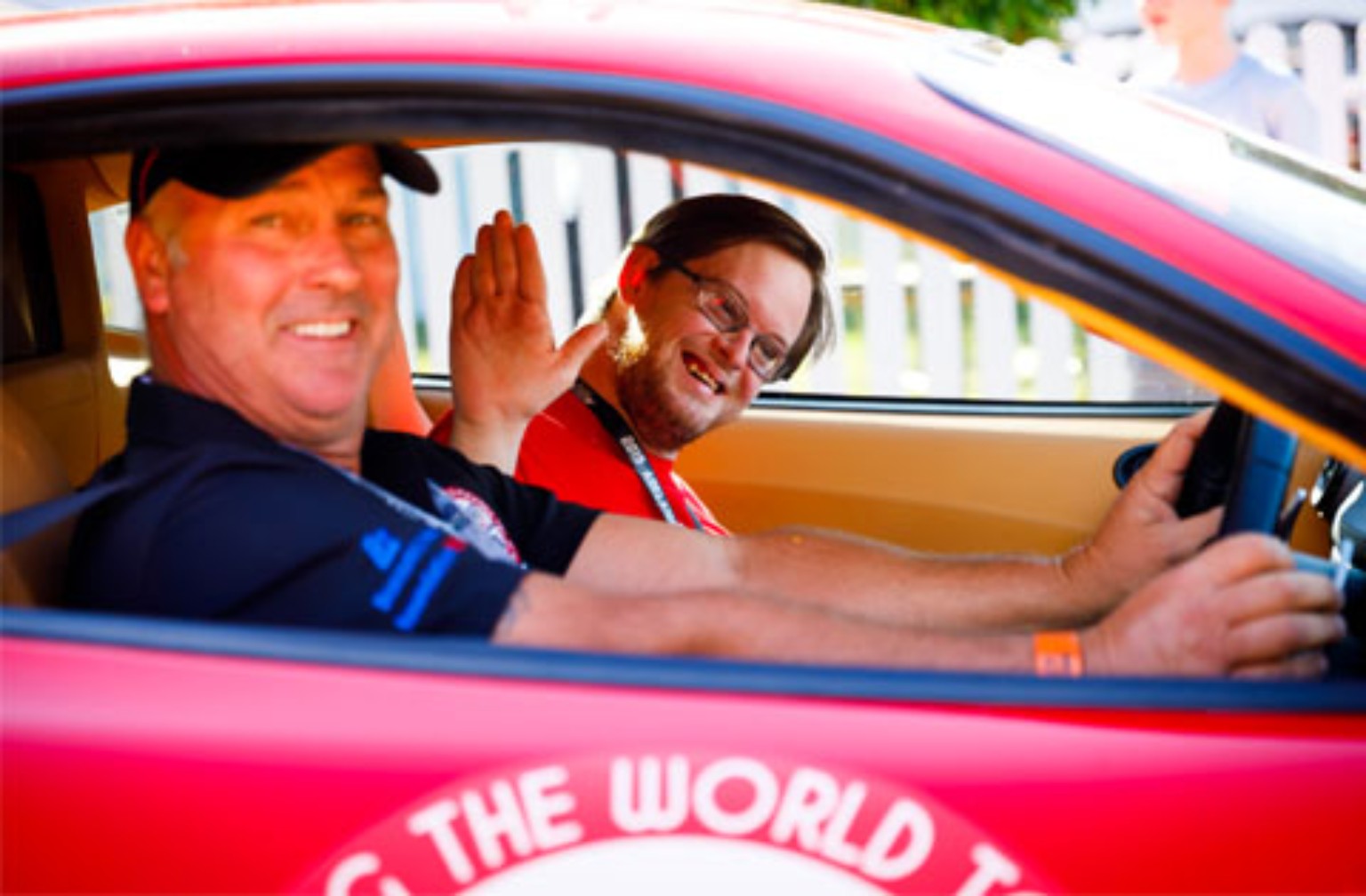 Dream Ride participant and driver sharing a moment in a sports car